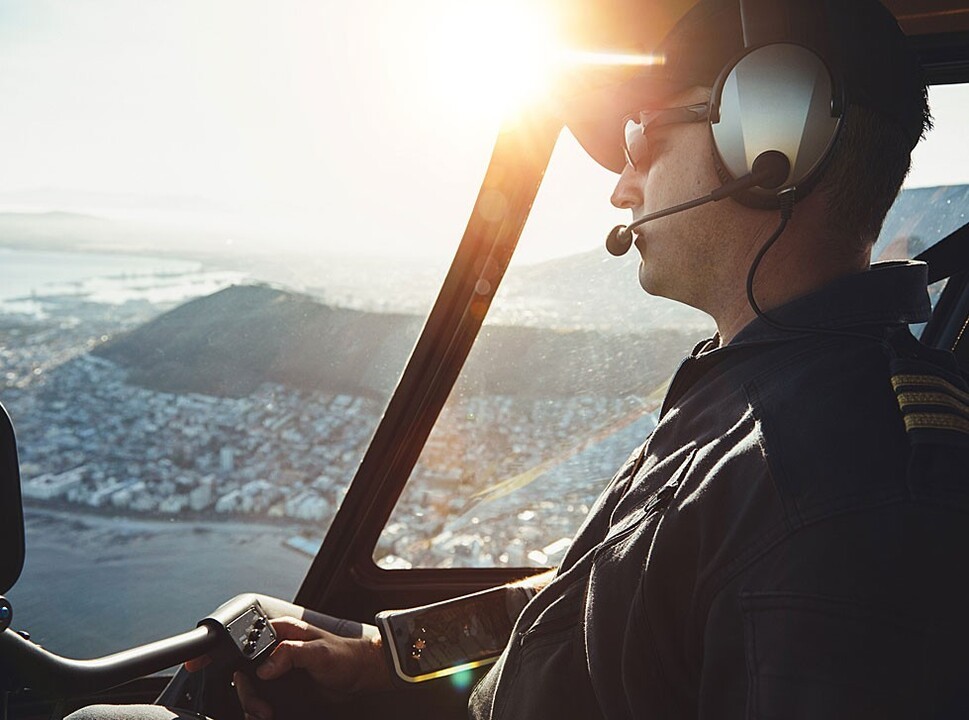 A pilot flies his turbine helicopter over Cape Town in South Africa