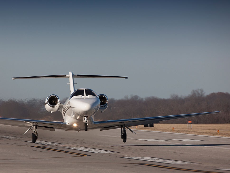 Cessna Citation light jet taking off from runway