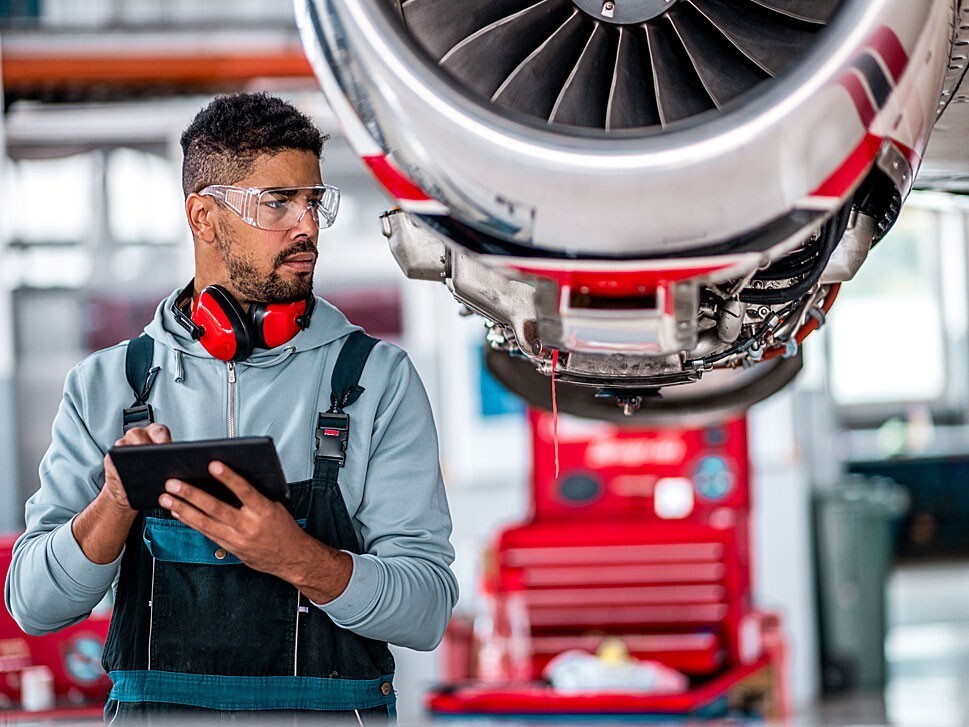 Private jet mechanic inspects engine